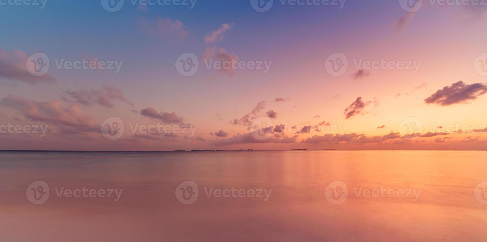 Amazing panoramic sunset seascape with colorful sky and calm sea on the horizon, dreamy ocean view perfect for meditation, inspiration, nature wallpaper, peaceful summer travel background photo