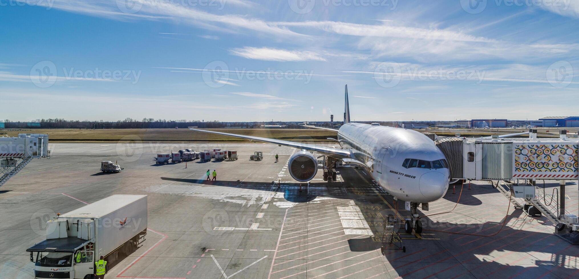 Airplane on runway in front of modern terminal preparing for takeoff, transportation background for air travel, tourism, vacation, business trip, international flight scene photo