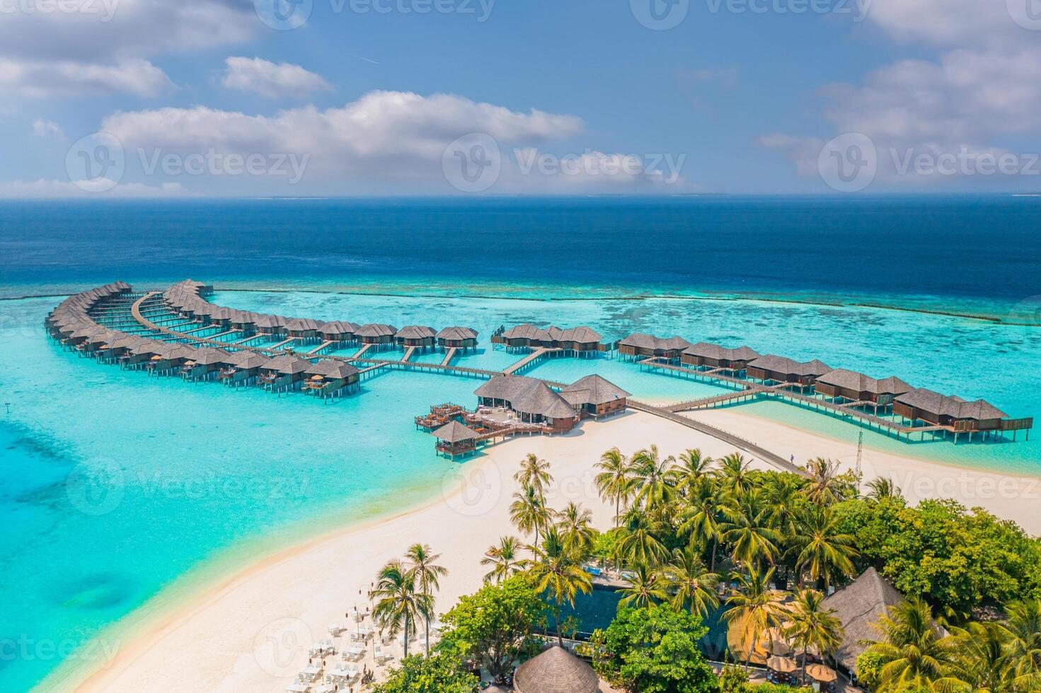 Aerial view of Maldives overwater villas and bungalows with beach landscape lagoon bay palm trees and idyllic summer scenery perfect for luxury travel peaceful nature and tropical island relaxation photo