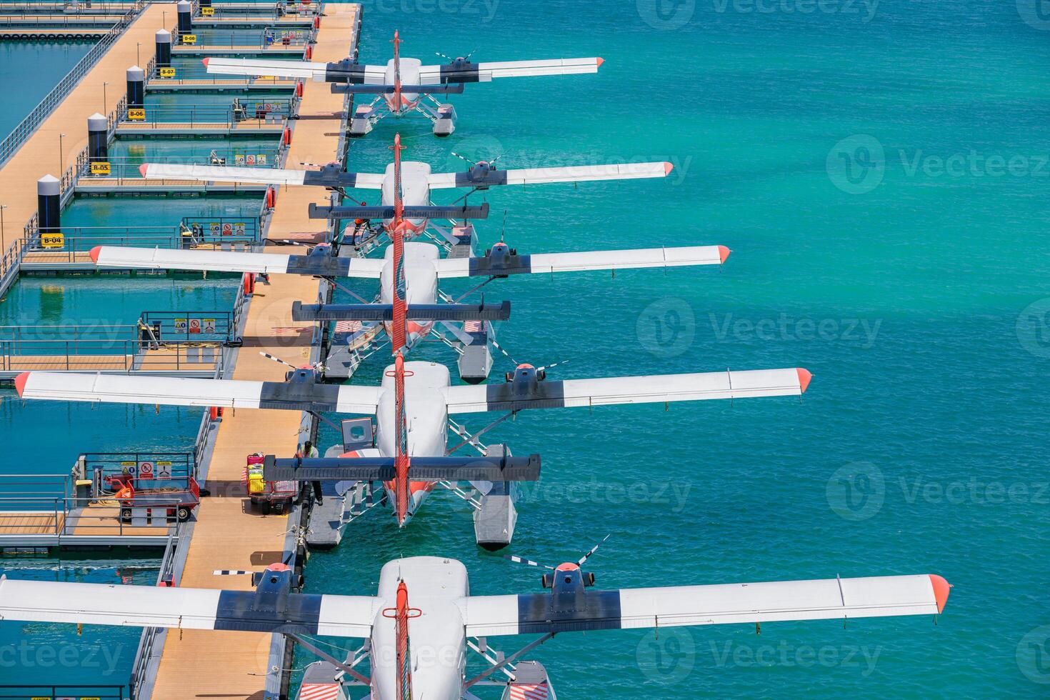 Aerial shot of Maldives seaplane preparing for takeoff from island dock over turquoise water scenic tropical destination luxury summer travel transportation vacation getaway photo