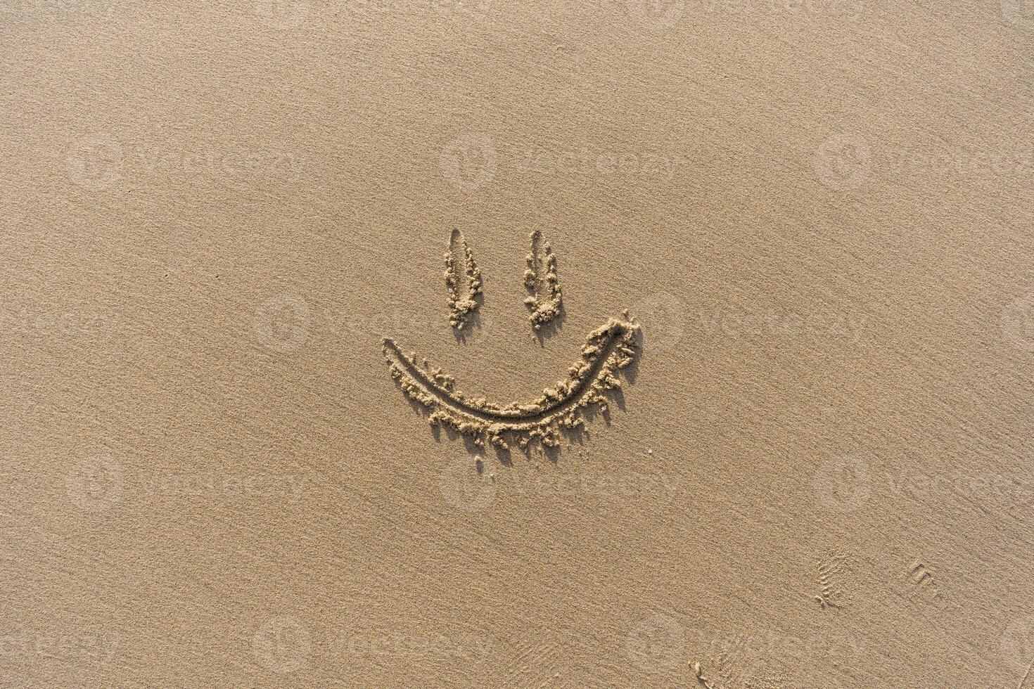 Smile Drawn On Sand Textured Background photo