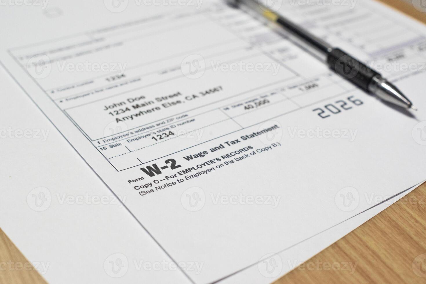 Tax document for the IRS W-2 Tax form on wooden table in office or home photo