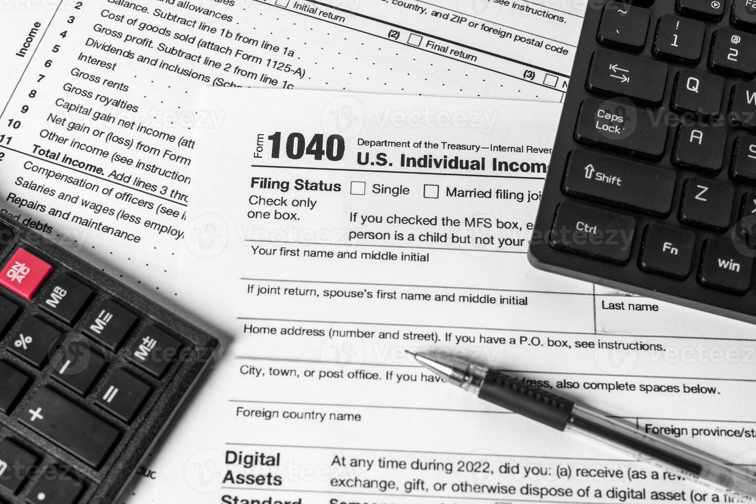 Filing taxes online with 1040 form, calculator, pen, and keyboard. Concept of electronic tax return before the deadline. photo