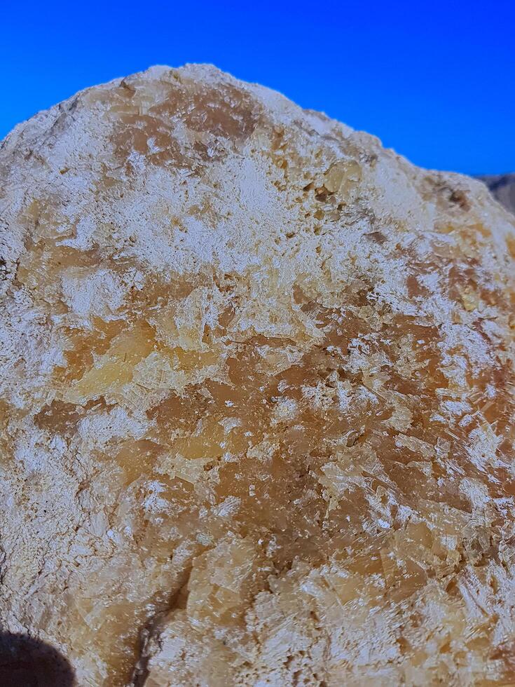 A naturally unmodified crystal rock is displayed in sunlight, with every distinct formation telling its own story, while the crystals' inherent allure is revealed in their authentic setting. photo