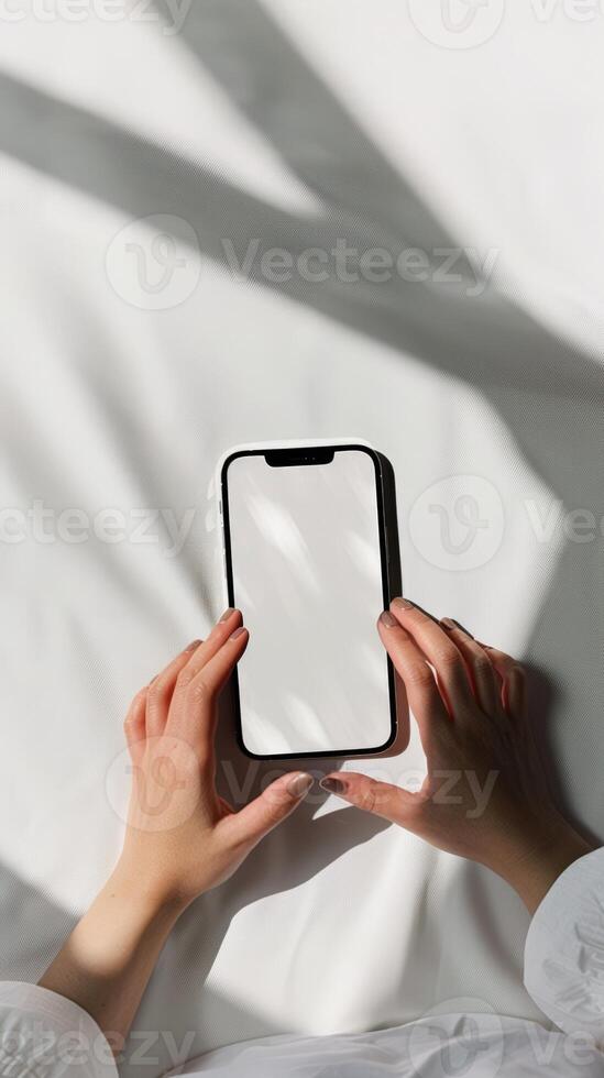 A person holding a smartphone with a blank screen photo