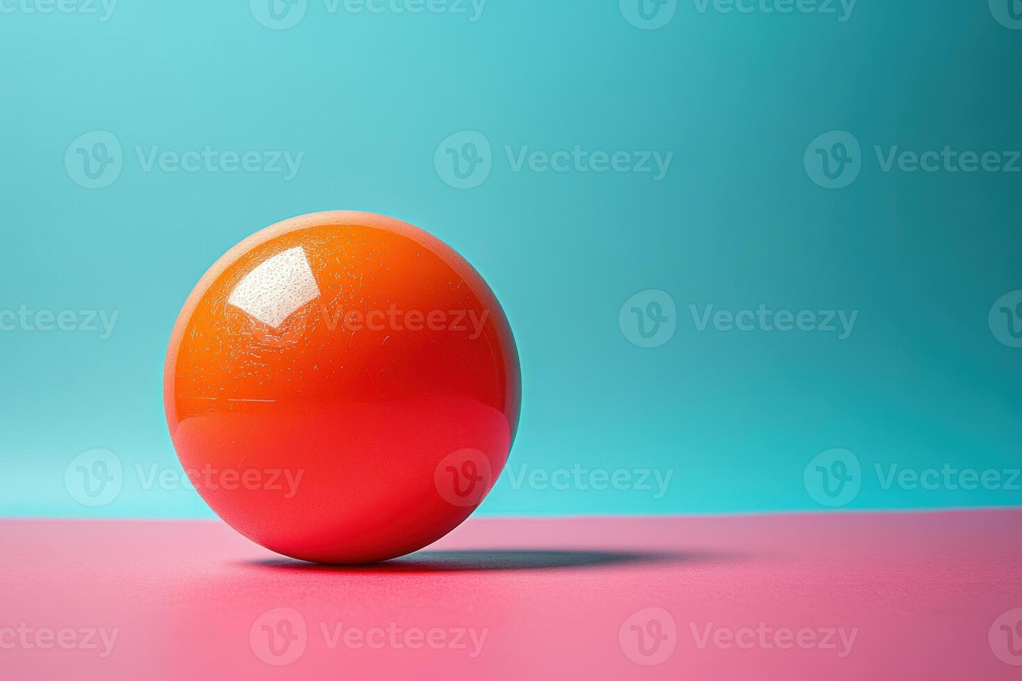 A red egg on a pink and blue background photo