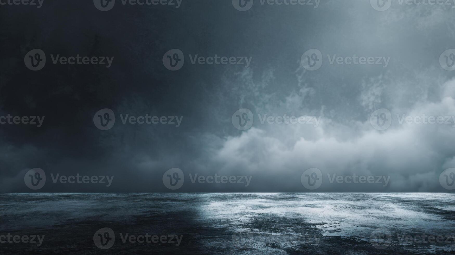 A moody seascape under a stormy sky depicting turbulent ocean waters meeting a dramatic cloudscape creating a sense of impending weather photo