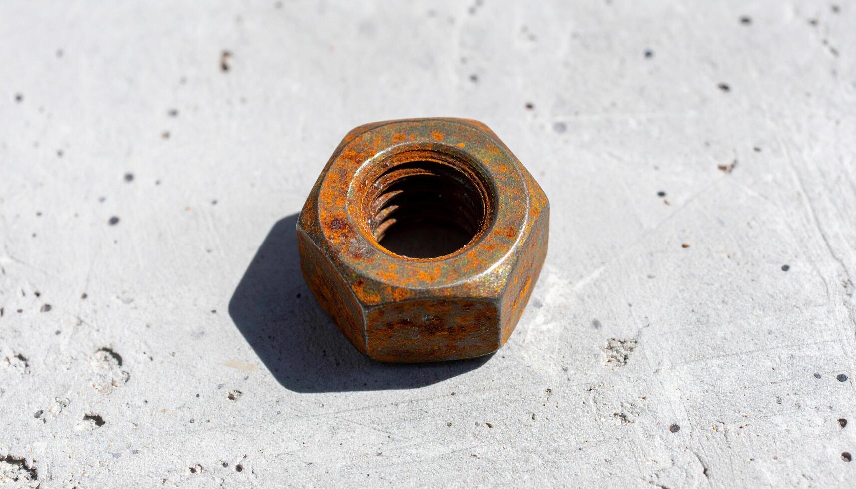 Rusted Hex Nut On Concrete photo