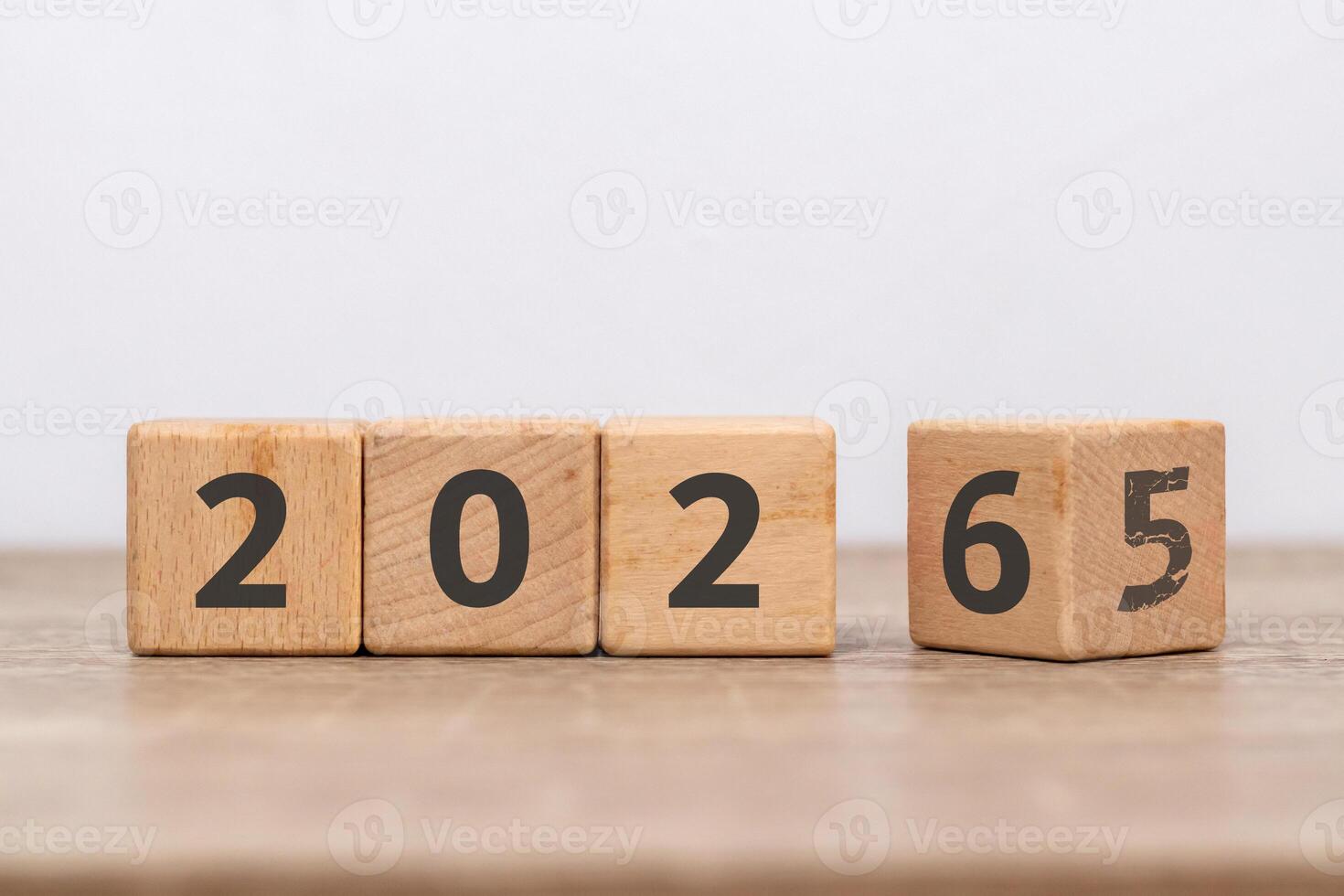 Wooden block with 2025 change to 2026 with the number five already faded. Turn of the new year. New year's resolution. photo