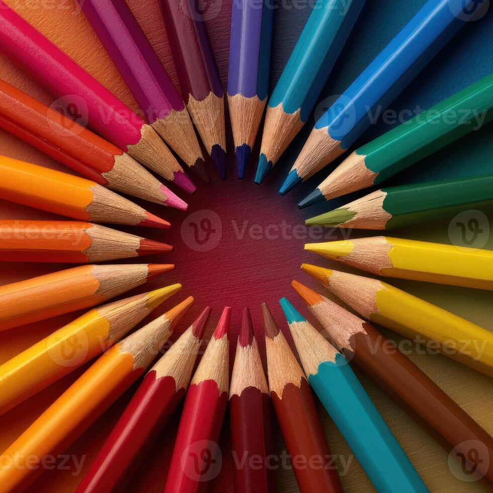 A vibrant and colorful array of drawing pencils arranged in a circular pattern forming a visually appealing spectrum of hues photo