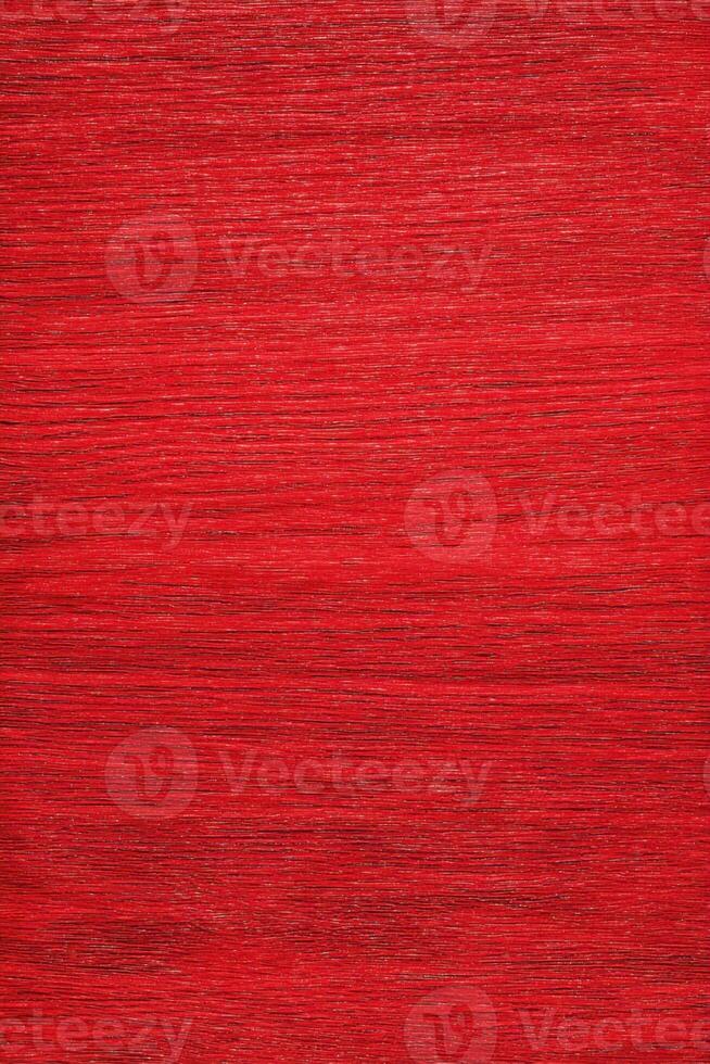 Detailed shot showing a textured background, featuring vibrant red hues, with fine lines and subtle gradients. photo