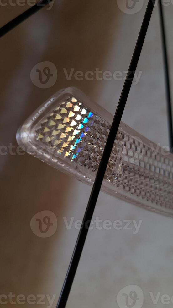 Prismatic display with rainbow spectrum and refracted light effect highlighting intricate geometric shapes and color transitions in captivating visual patterns photo