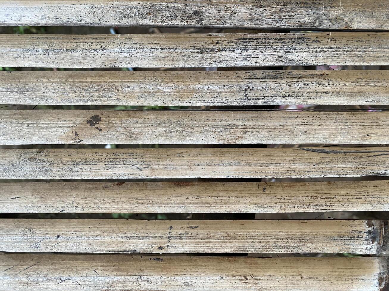 Weathered wooden slats create a textured with a rustic and aged appearance. photo