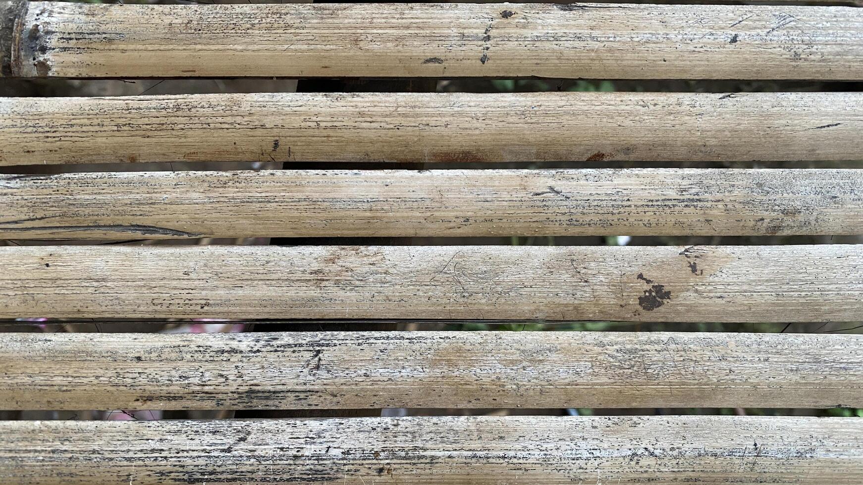 A close up of a wooden fence with some holes photo