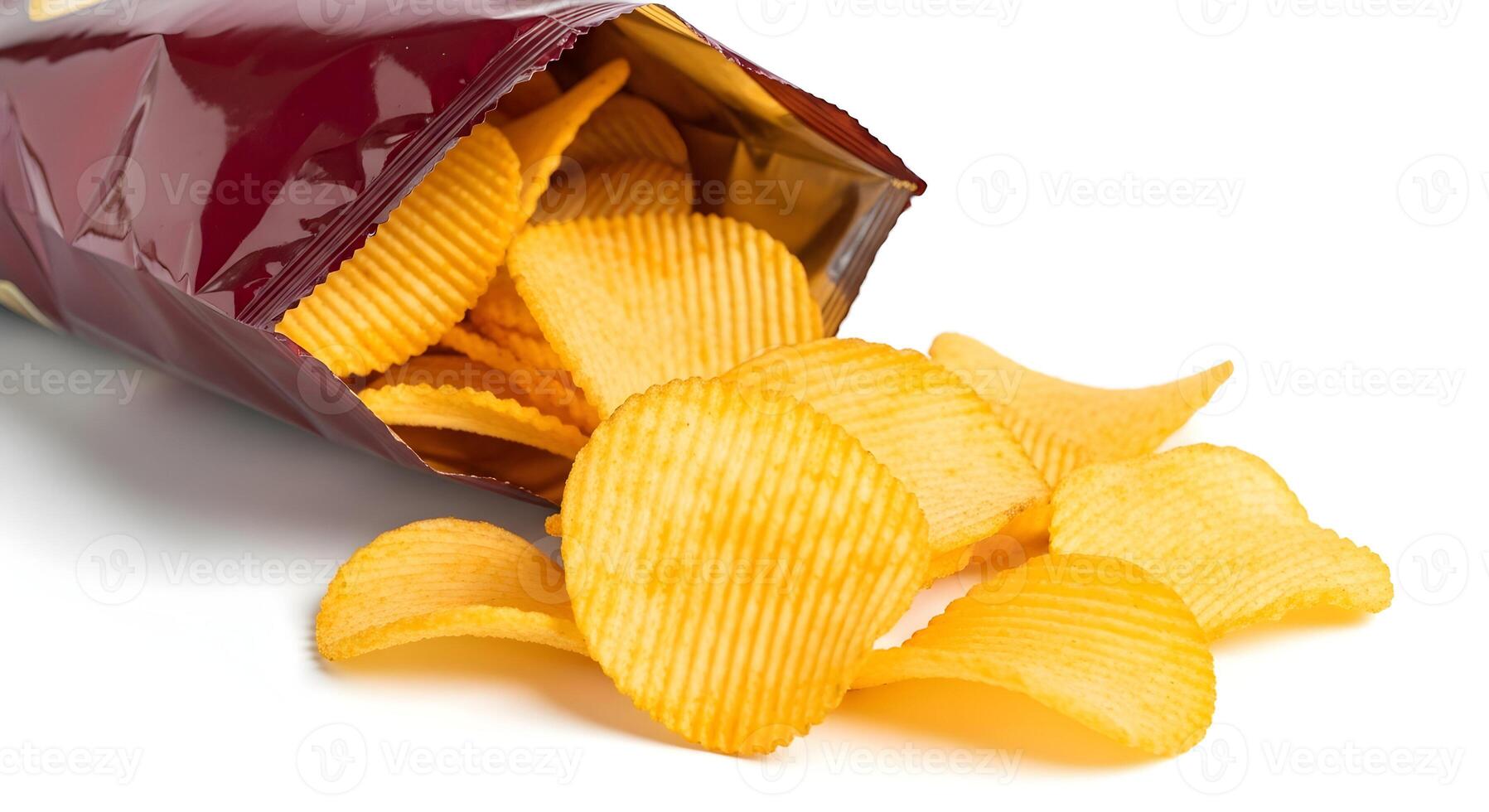 Open bag of rippled potato chips spilling out onto a black surface in a close up studio shot photo