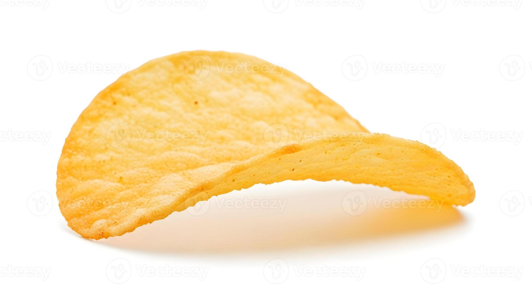 A single potato chip isolated on a black background with a slight curve and golden yellow color tone photo
