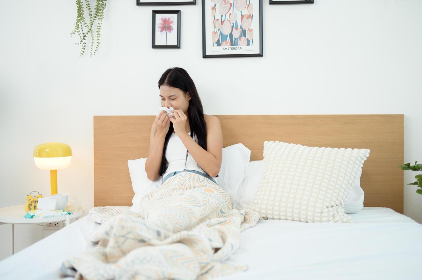 Young asian woman feeling sick in her bedroom photo