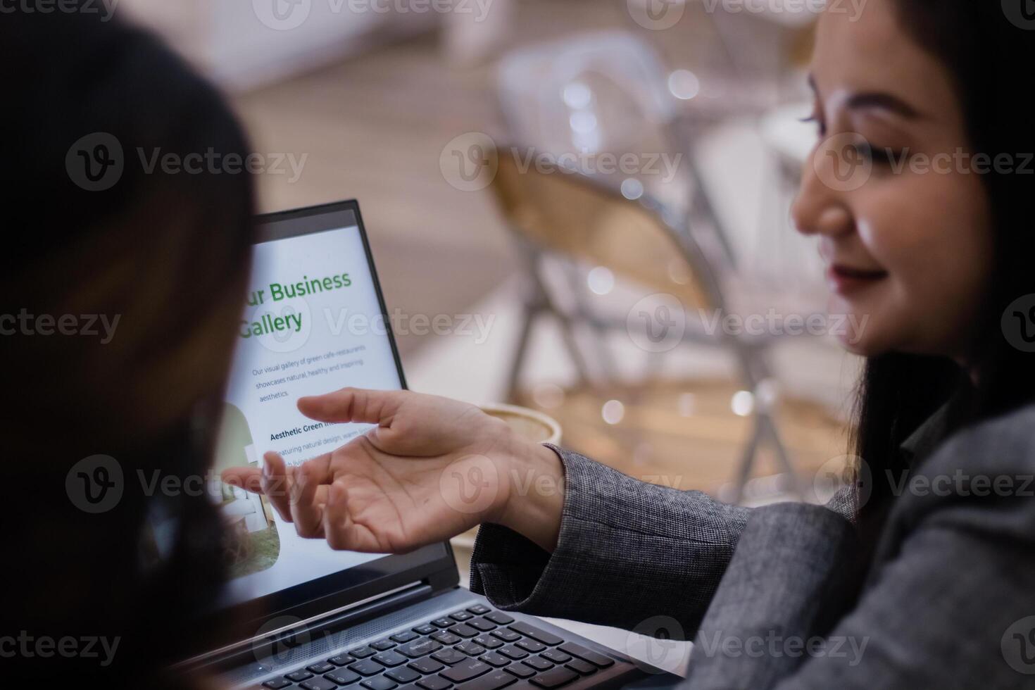 Team Discussing Business Portfolio on Laptop photo