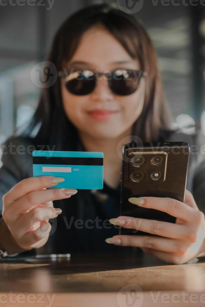 Effortless purchasing woman utilizing credit card and mobile ph photo