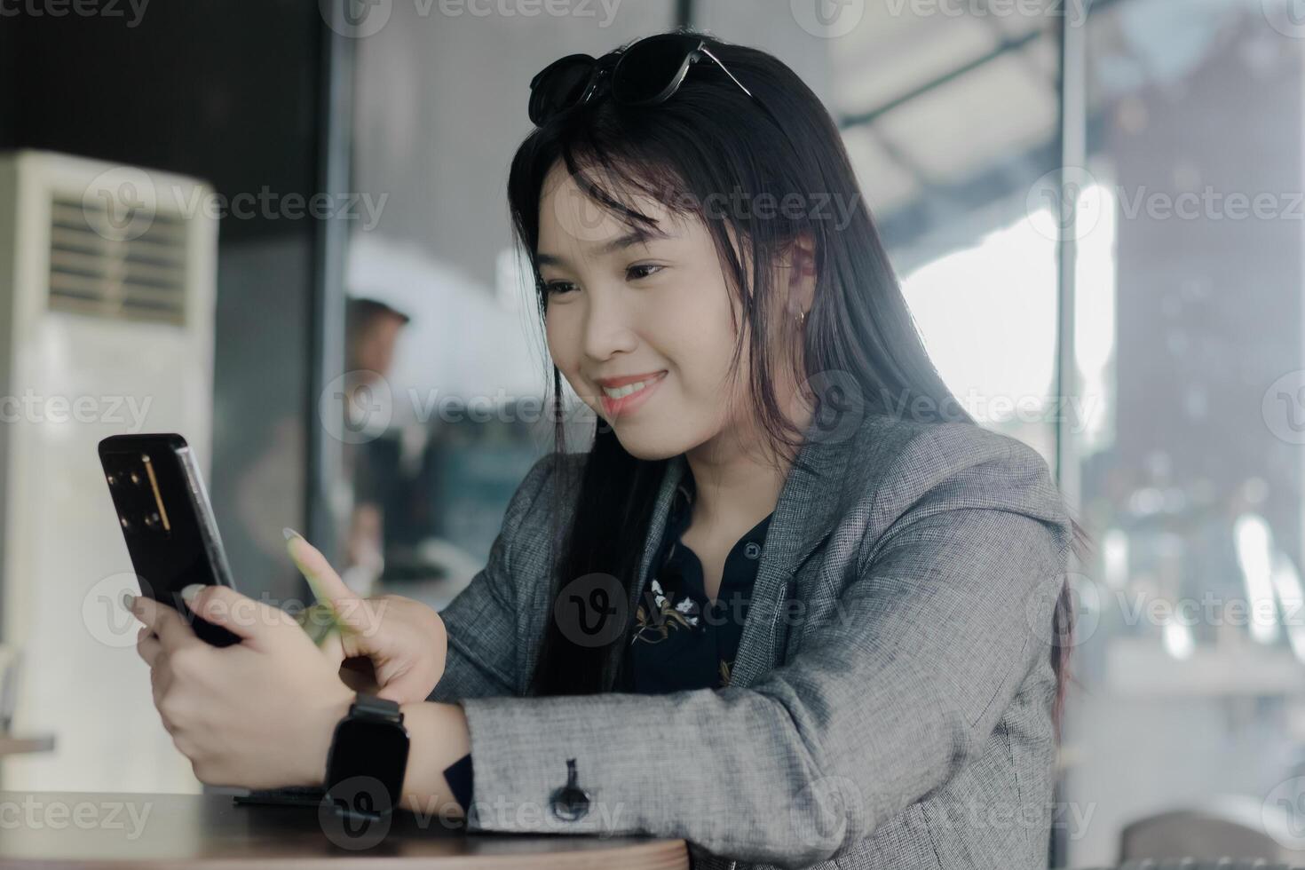 Young businesswoman using smartphone for call at a cafe ta photo