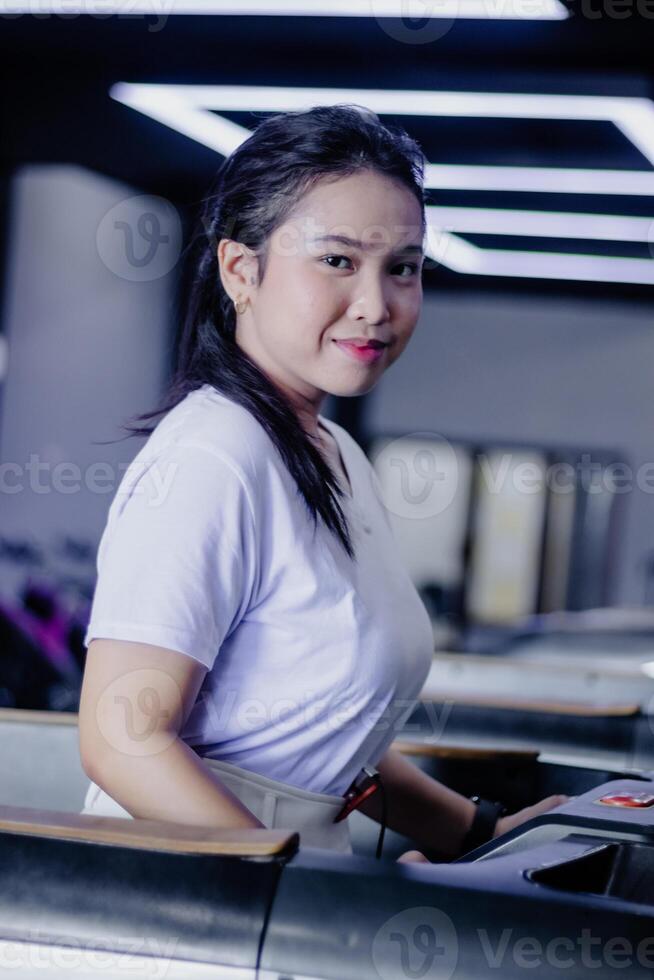 Confident woman exercising on treadmill at modern fitness center photo