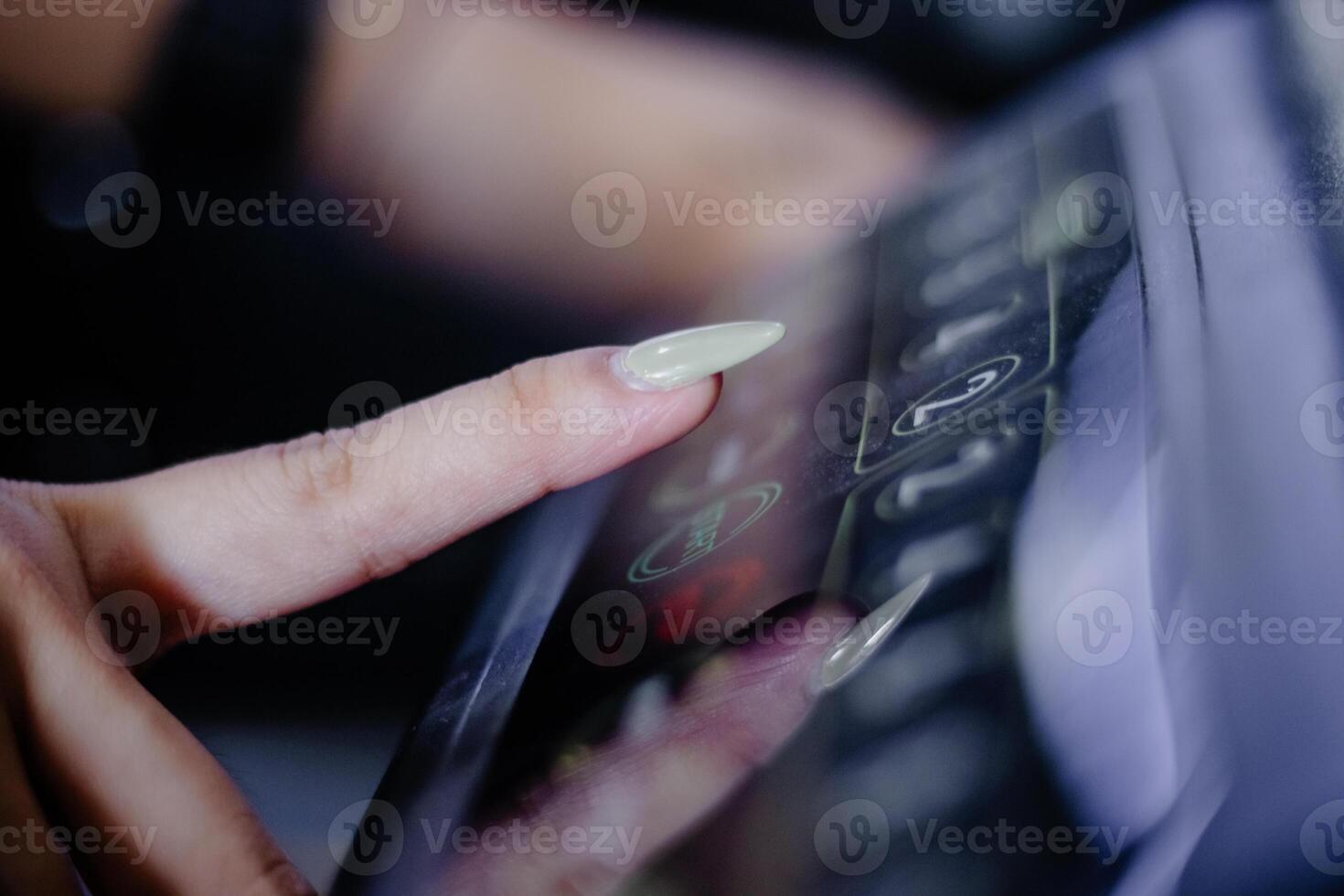 Close-Up of a Woman Pressing a Button on an Elevator Panel photo
