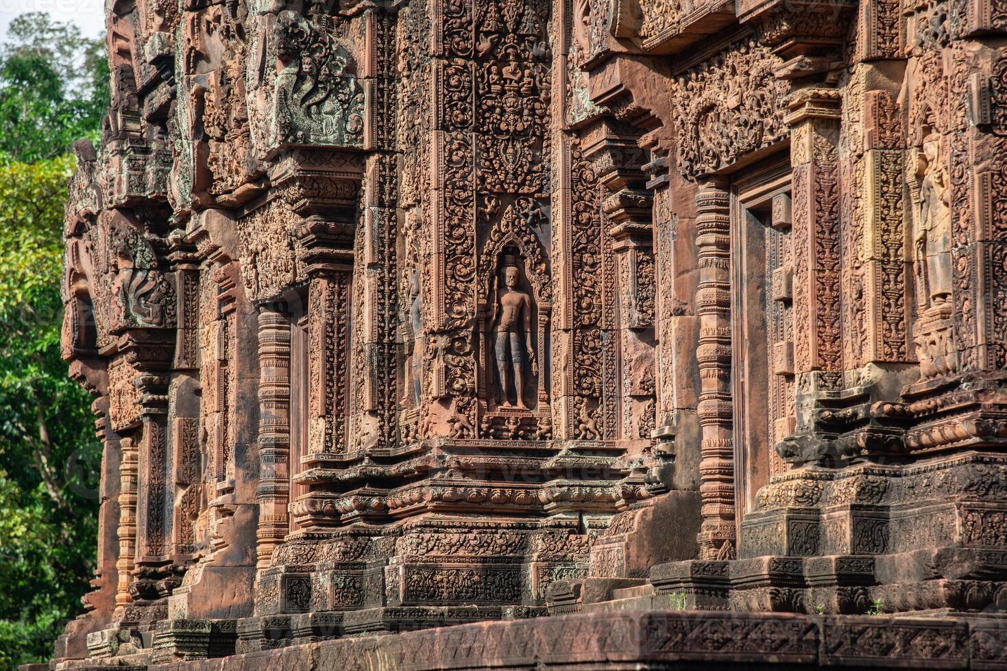 Beautiful bas relief in Banteay Srei a 10th century Cambodian temple dedicated to the Hindu god Shiva made by pink and red sandstone in Siem Reap, Cambodia. photo