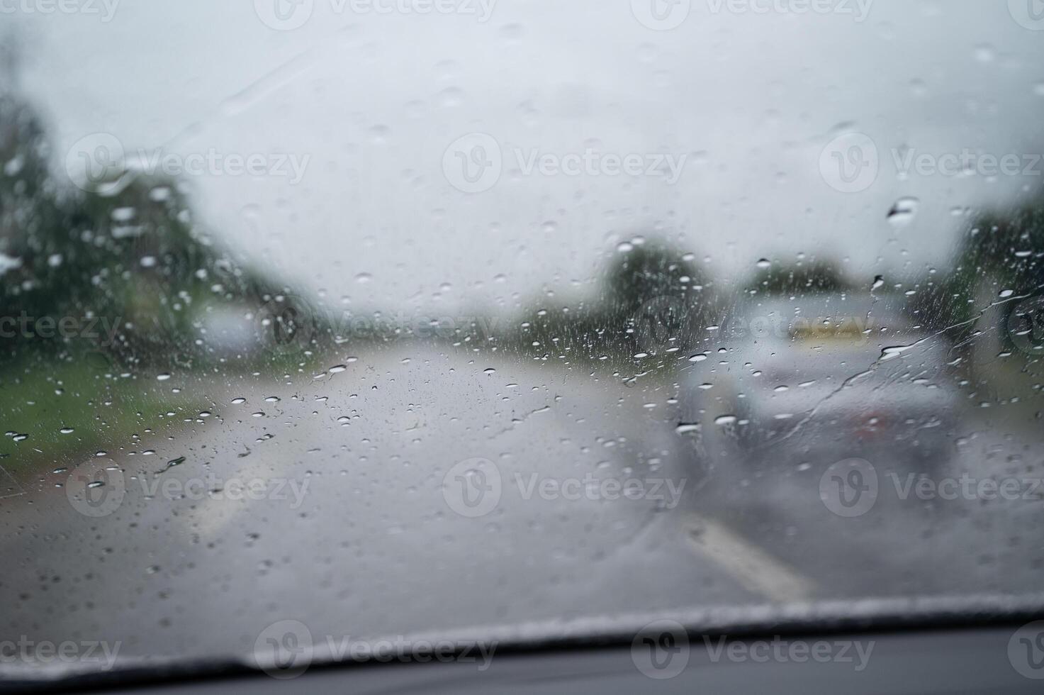 Rain drop on the car glass window while driving on the road. photo