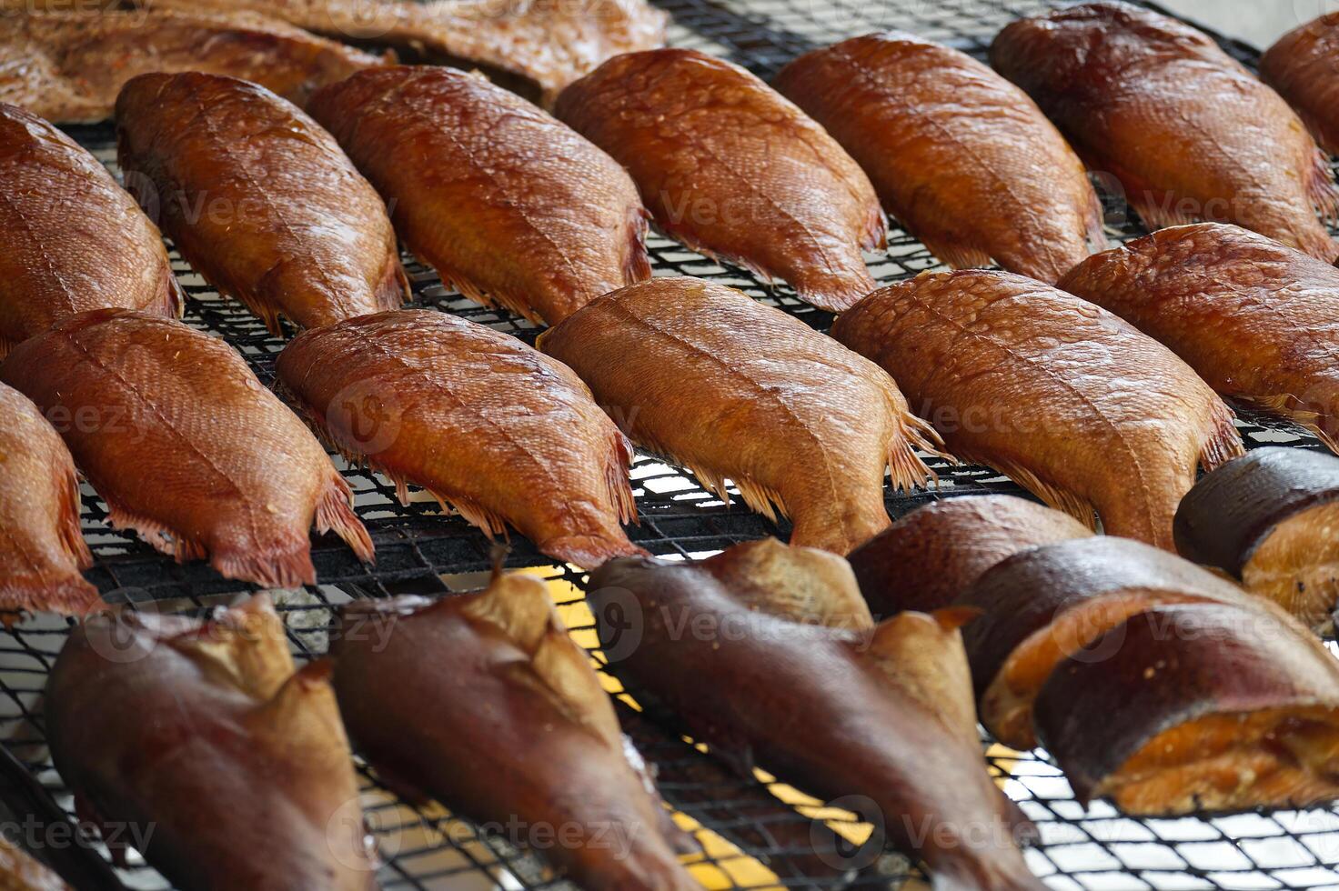 Delicious Smoked Fish Displayed on a Grill for Fresh Seafood Presentation photo