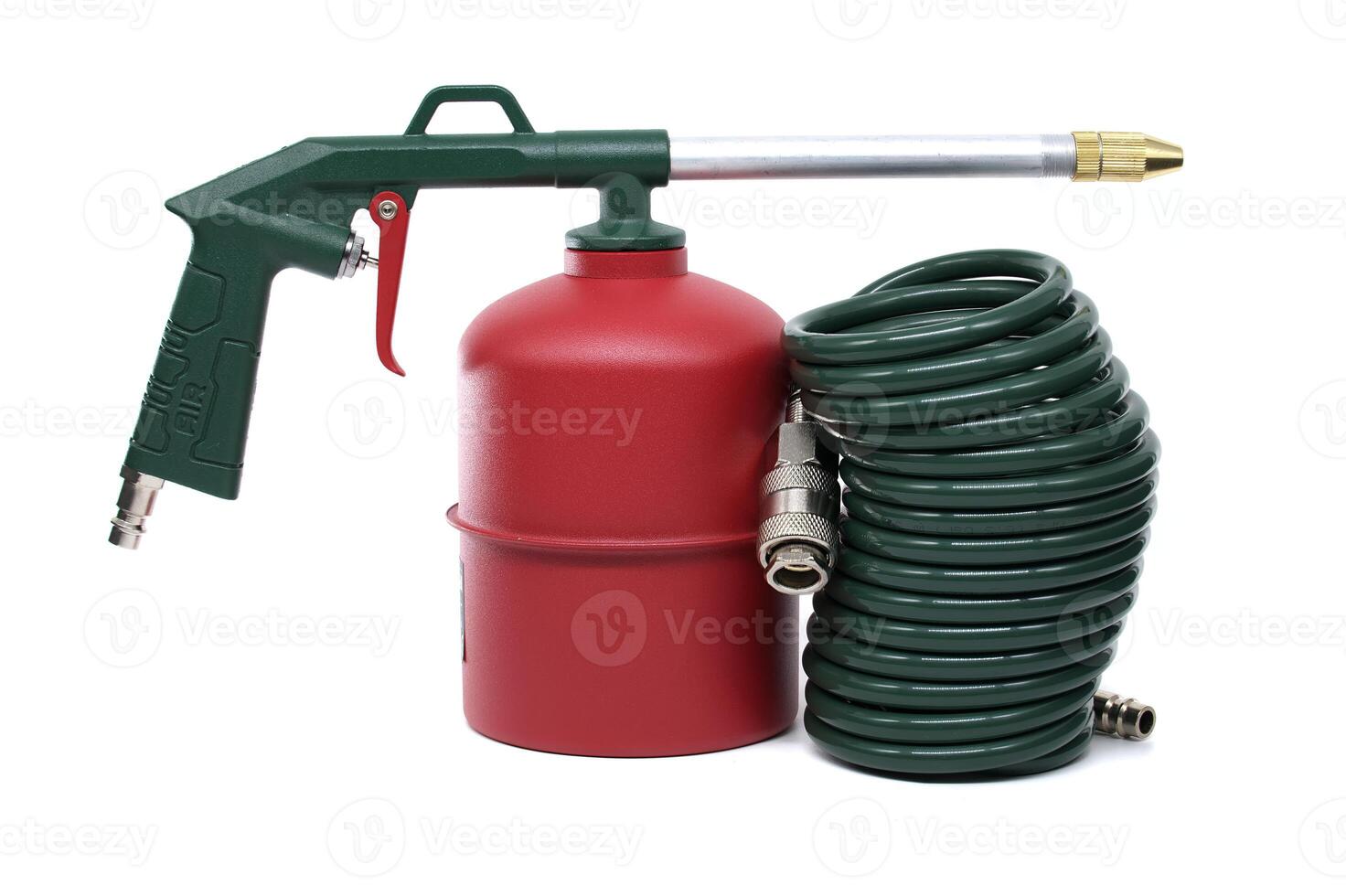 A close-up shot of an industrial air gun with a green hose and air tank on white background. photo