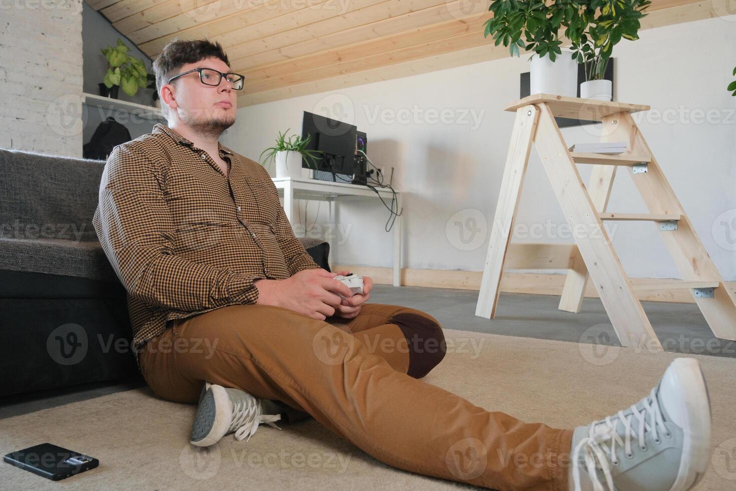 Focused man playing games using controller photo