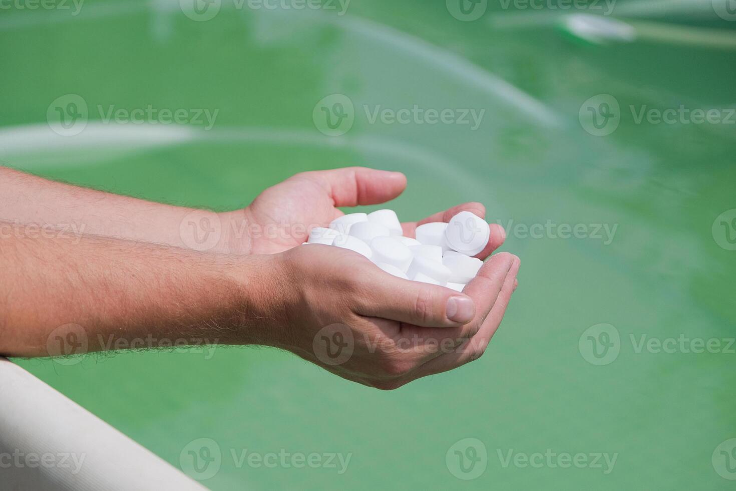 man hands holding salt for cleaning dirty pool photo