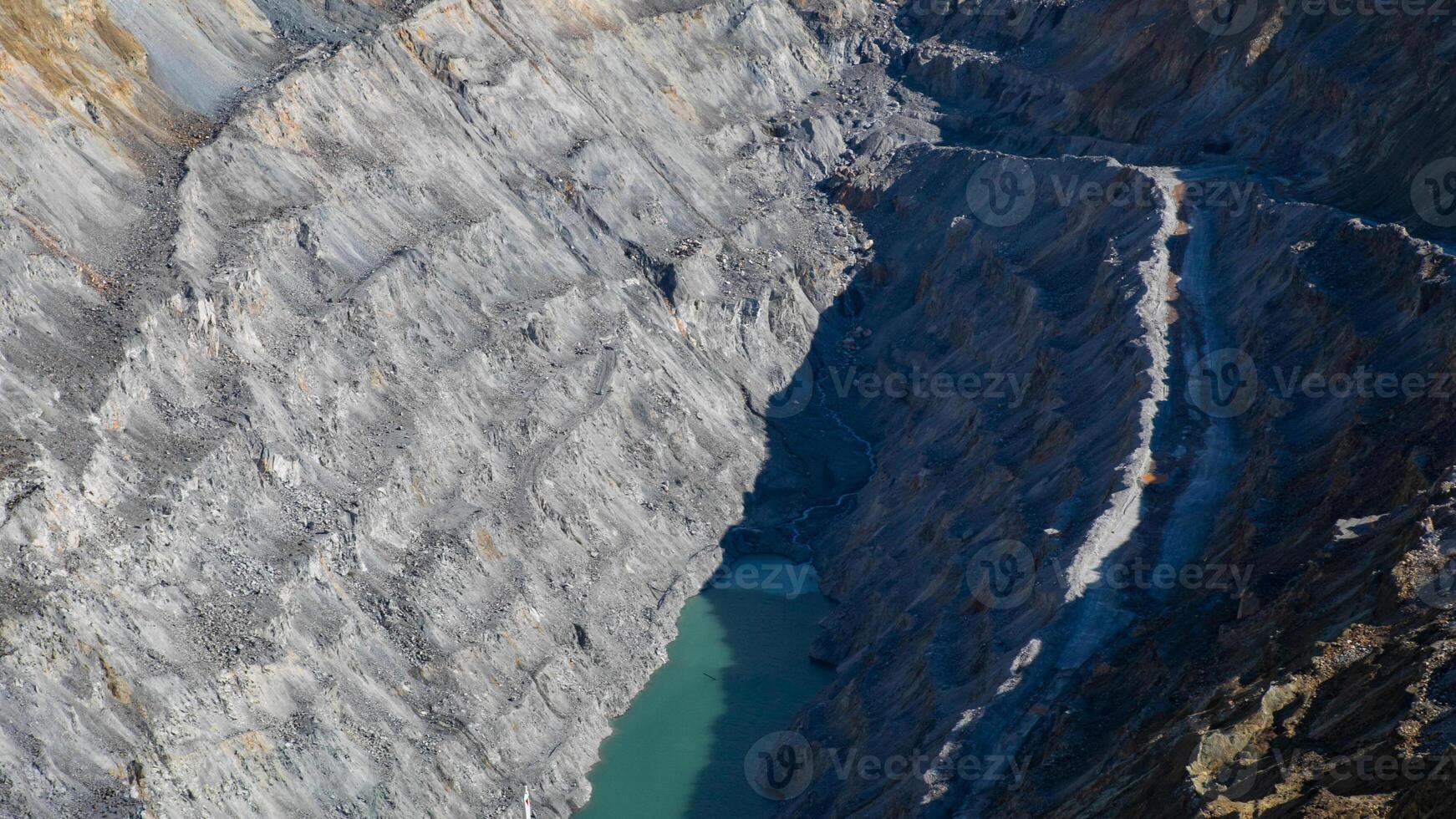 Vertical chasm with emerald waters, echoing Earth Day depth, geological wonderment, and whispering secrets of subterranean realms photo