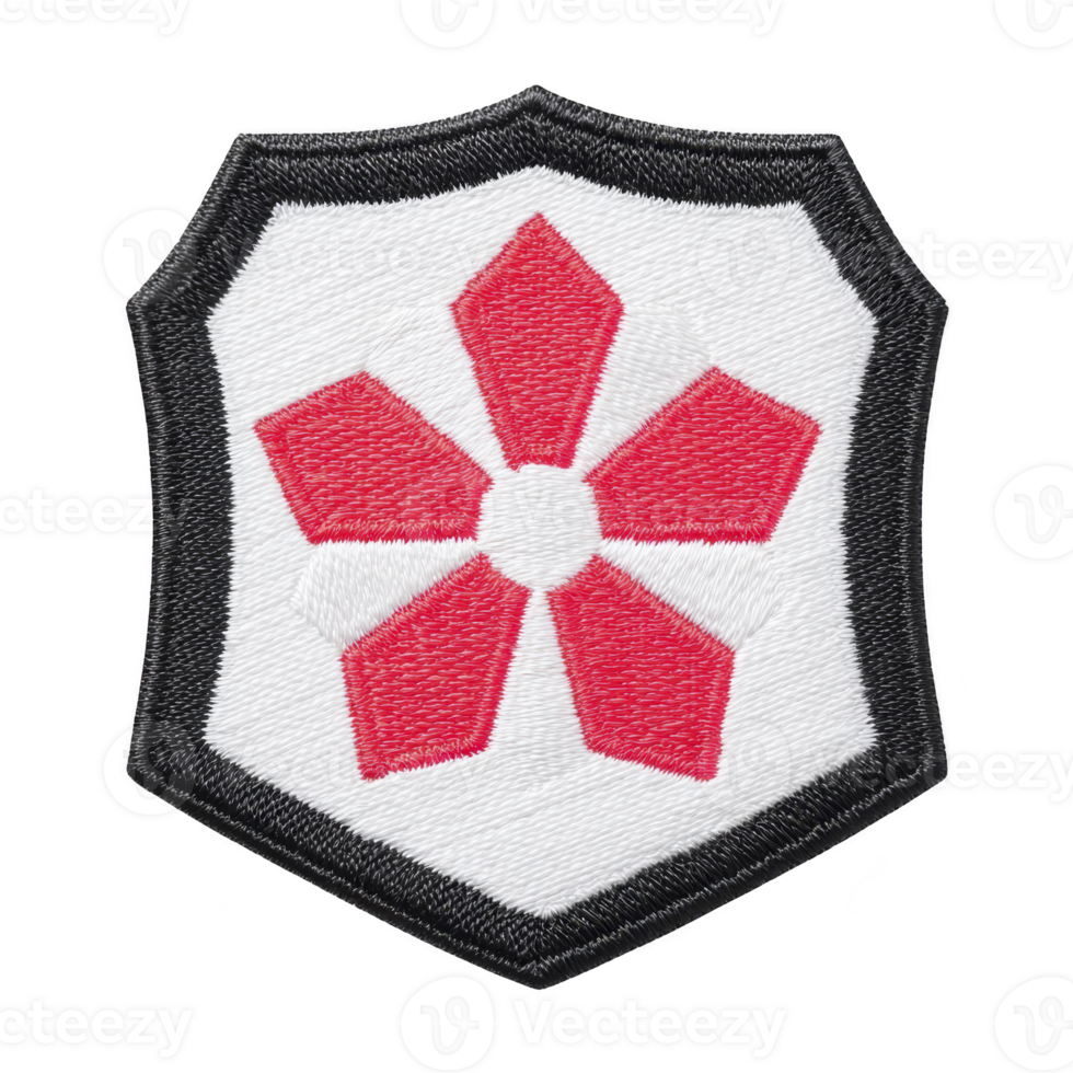 This shows embroidered patch featuring red geometric flower design transparency background, bordered by black shield shape. patch has symmetrical and bold appearance, often used for decorative png