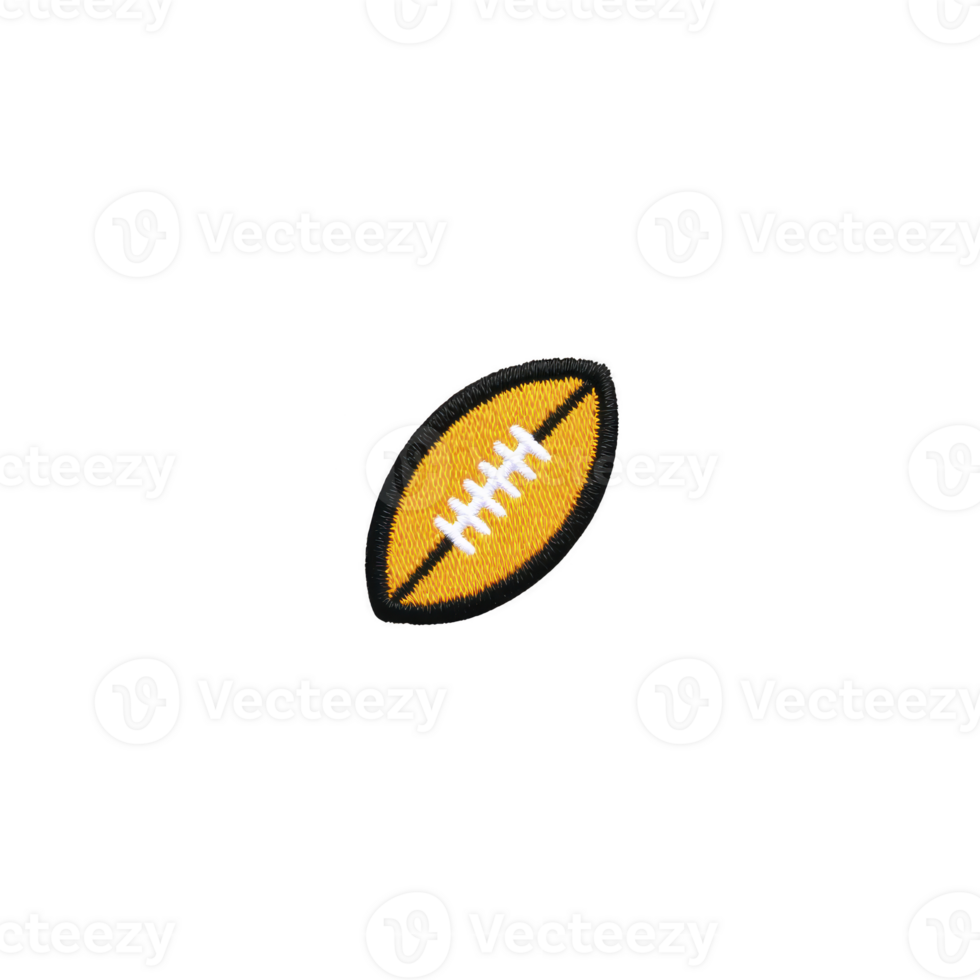 Small embroidered patch in shape of American football, featuring yellow and white design, is displayed on plain background. patch is oval with detailed stitching png