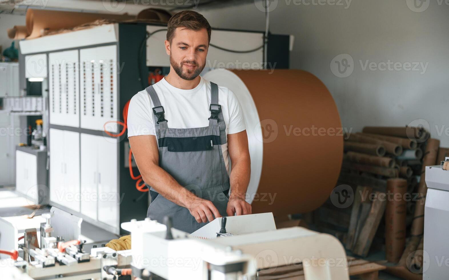 Handsome, manm is working at the factory of creating eco boxes photo