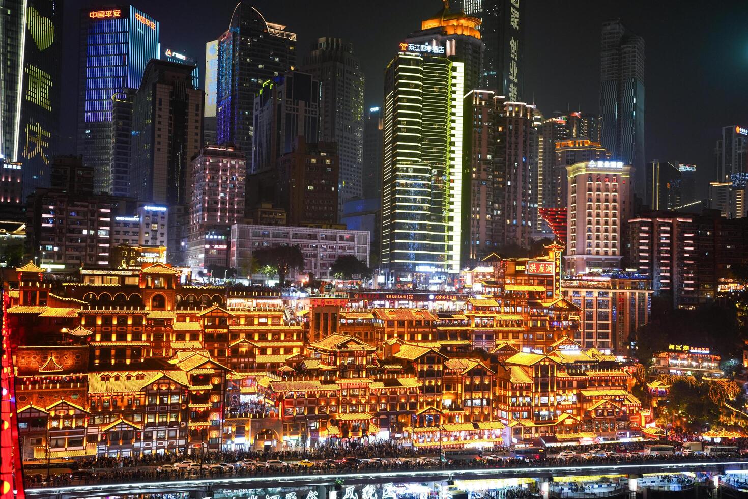 Chongqing, China-APR 02, 2025- Night view Cityscape of the famous downtown shopping complex Hongyadong with illuminated bridge and highrise building in Chongqing photo