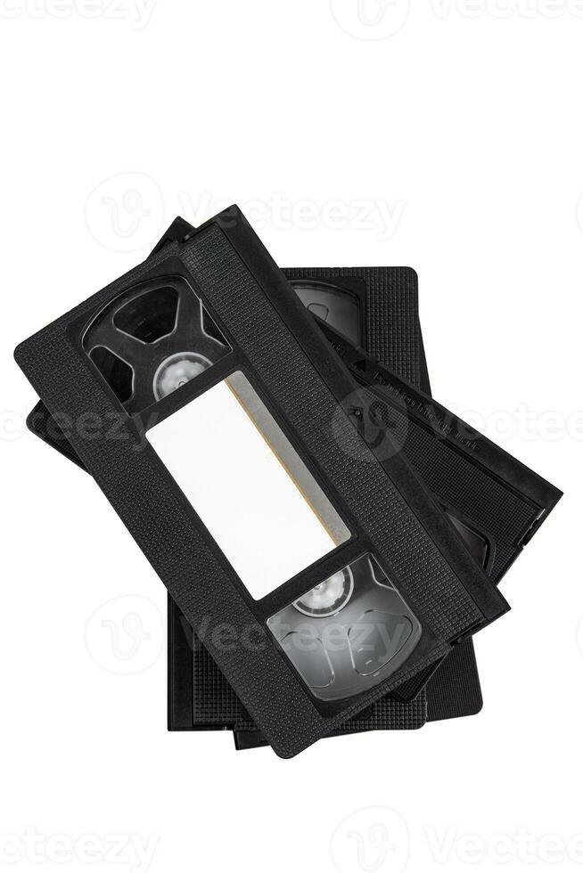 A set of old black VHS tapes stacked neatly, representing a bygone era of film technology. photo