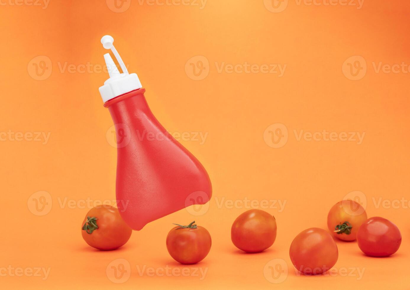 Chili sauce with ketchup, plastic sauce bottle isolated on yellow background. photo
