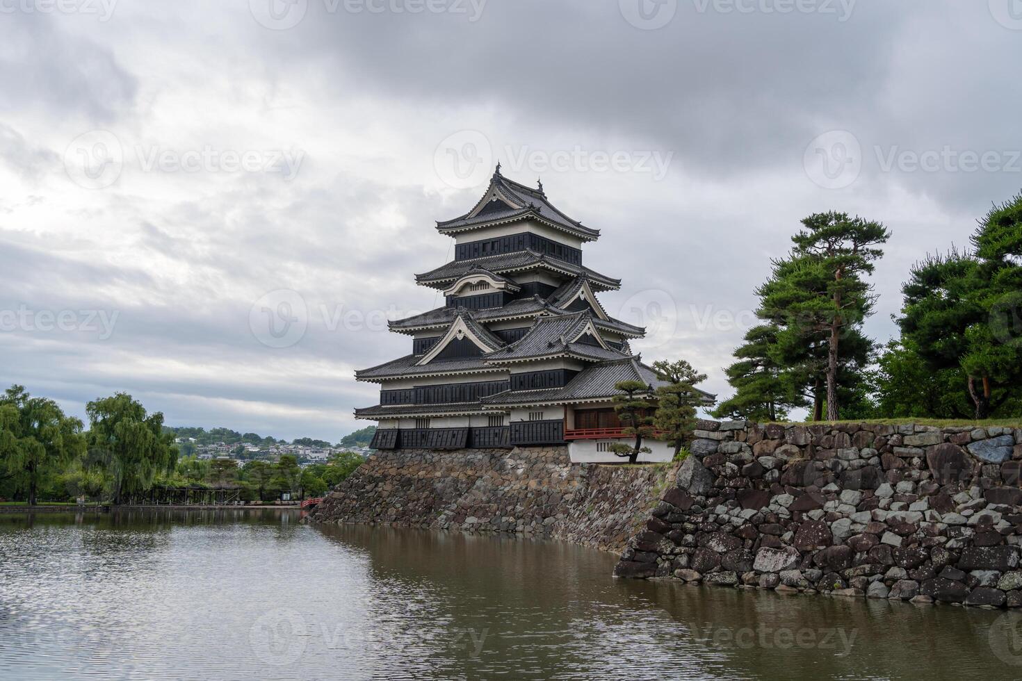 Historic Matsumoto Castle reflected in calm waters, Japan photo