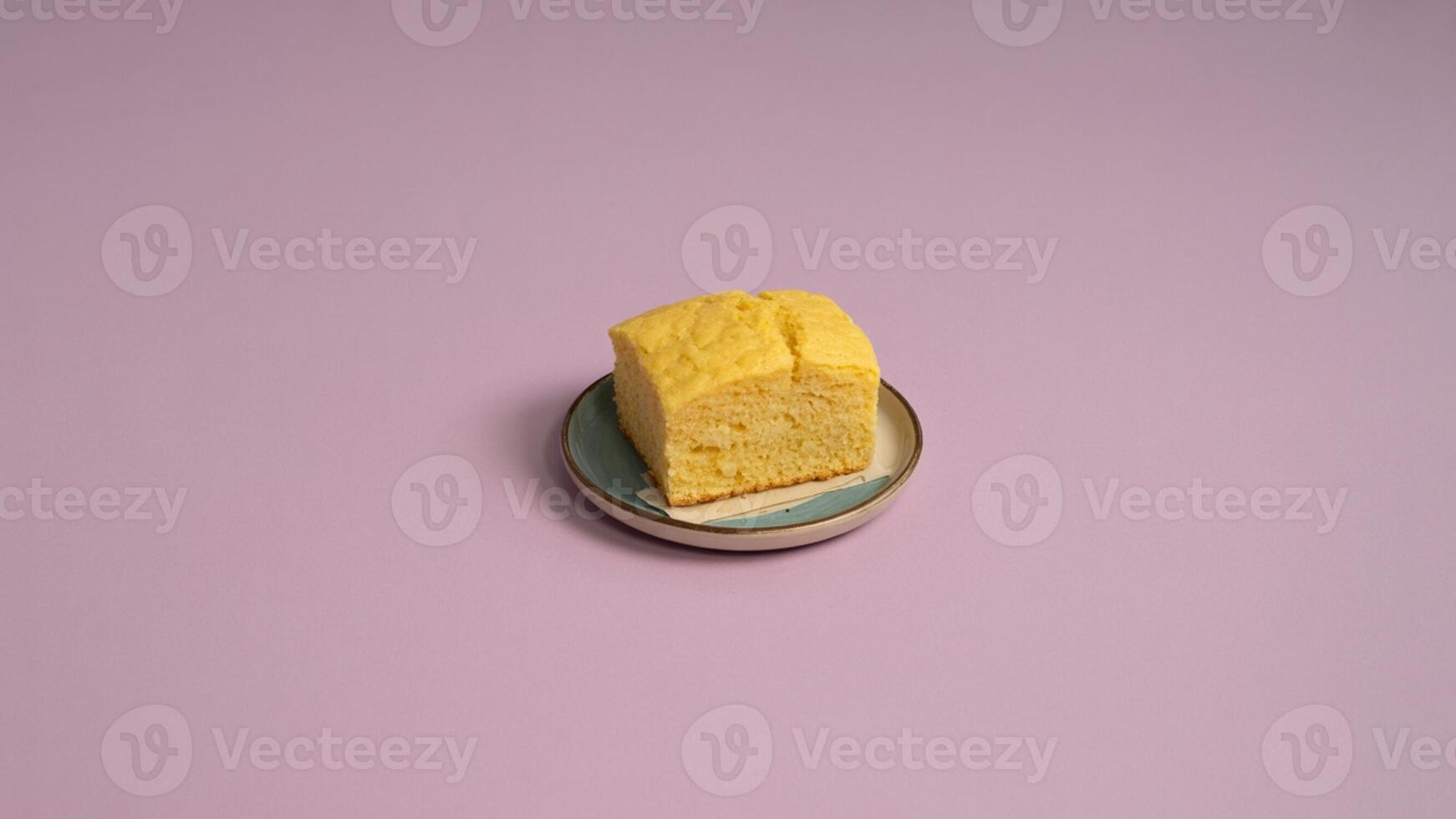 a delecta ble pile of crea m puffs dusted with powdered suga r on a vinta ge pla te a ga inst pink ba ckdrop photo