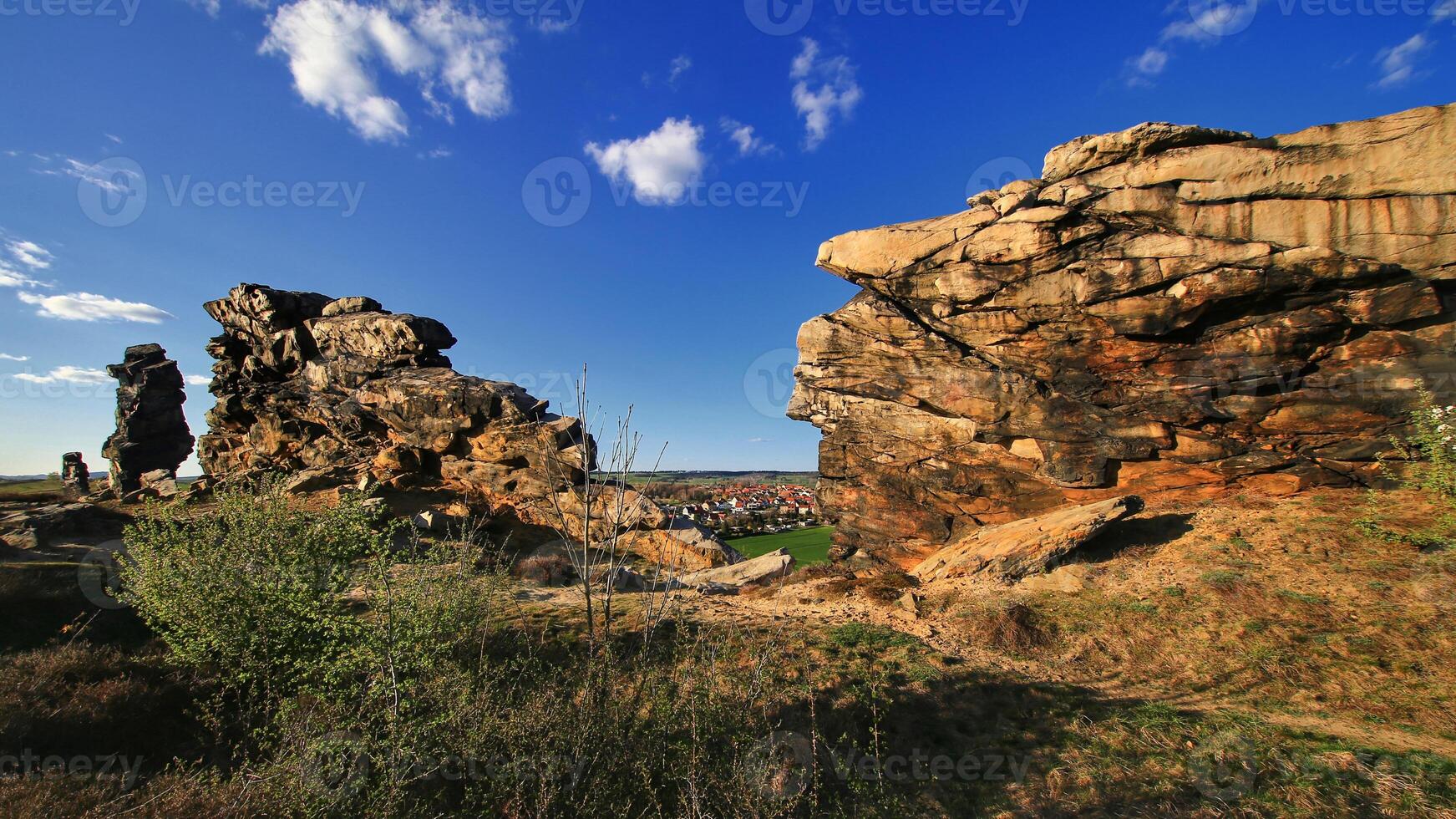 Rock formations divide landscape view toward Weddersleben, Germany village at golden hour photo