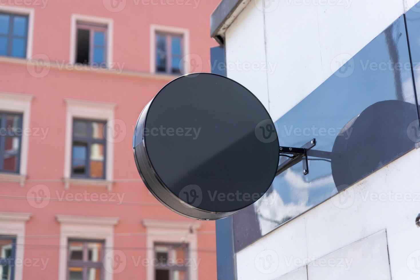Blank round shop sign on mirrored panel, perfect for minimalist branding mockups, trendy retail visuals or stylish urban business design photo
