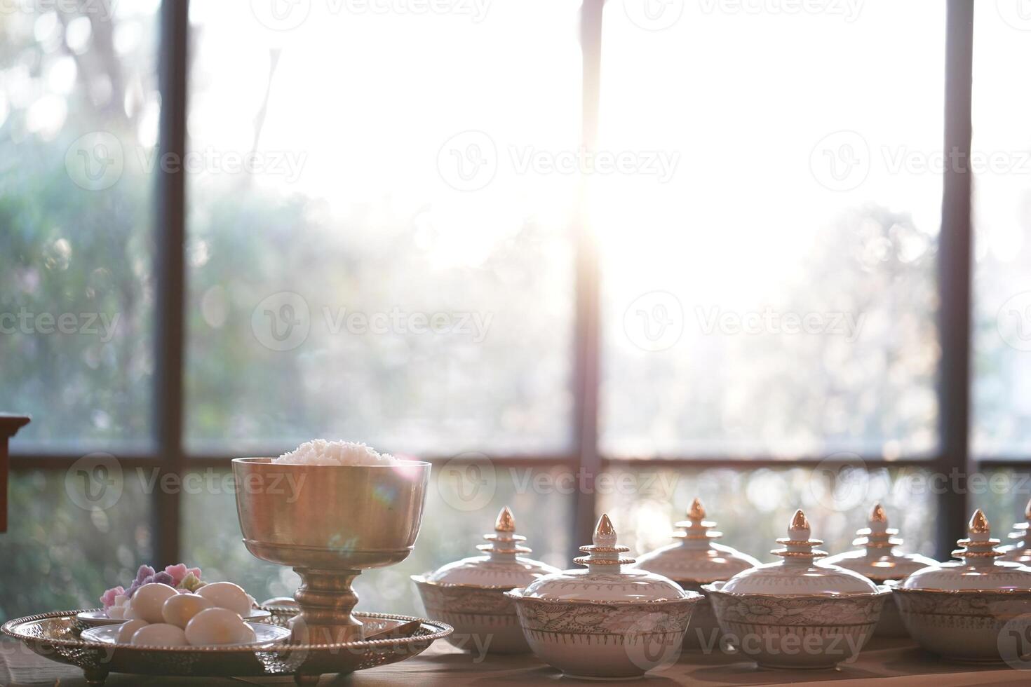 Thai bowl set on table prepare for give food offerings. to a Buddhist monk in the morning. People usually prepare rice, dishes and flower offer food to monk. photo
