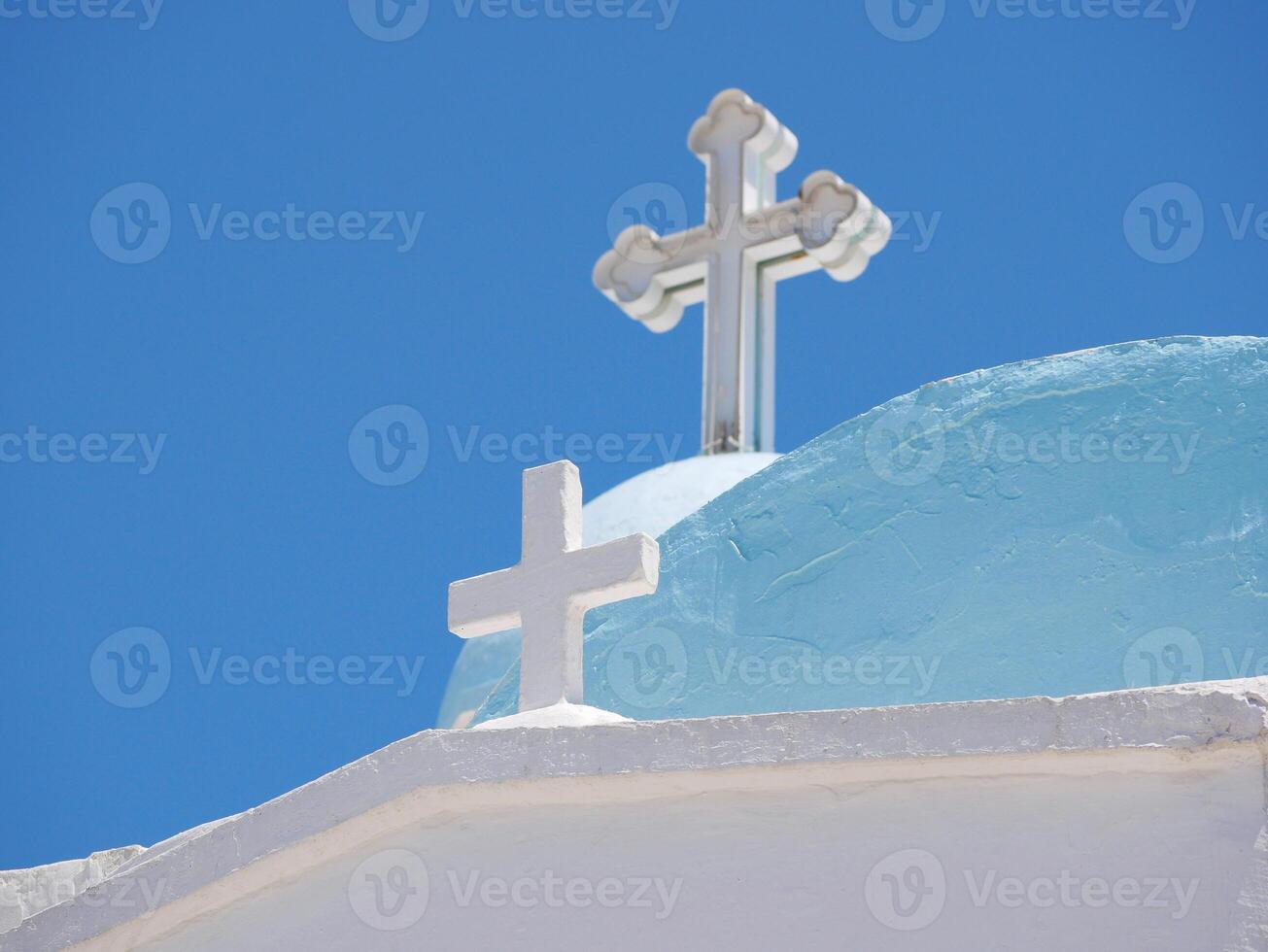 Traditional Greek Orthodox Church at the Lycabettus hill in Athens. Blue dome and white crosses close-up against sky photo