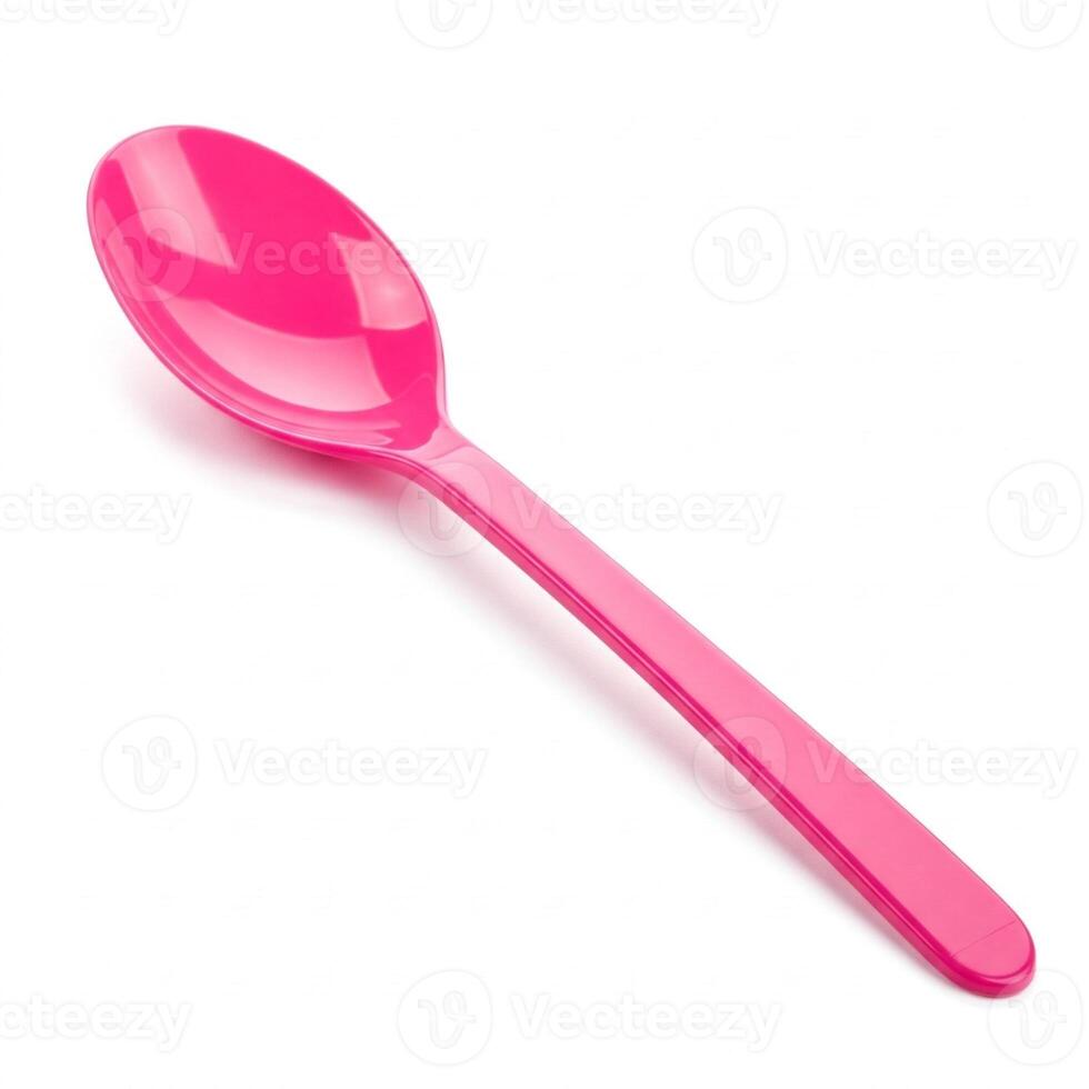 A pink plastic spoon isolated on white photo