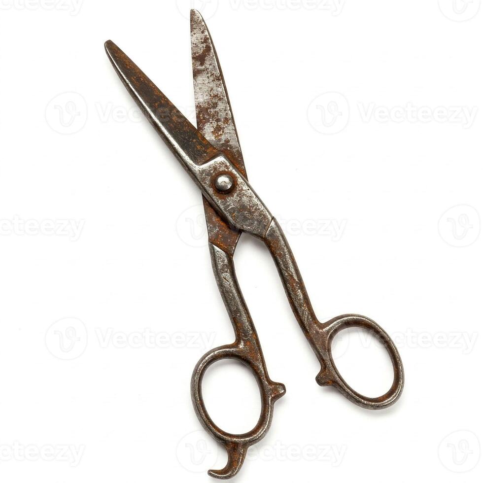 Old rusty metal scissors isolated on white photo