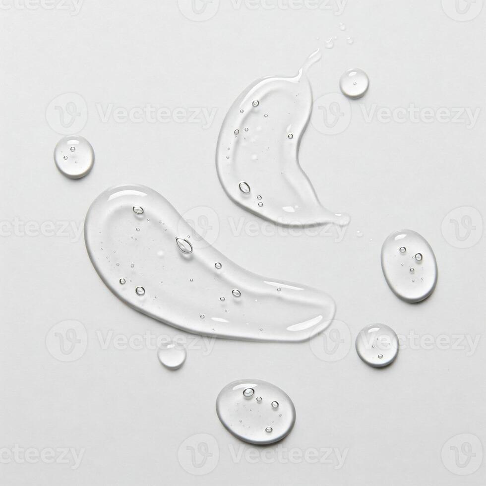 Clear cosmetics serum smeared on a white surface photo