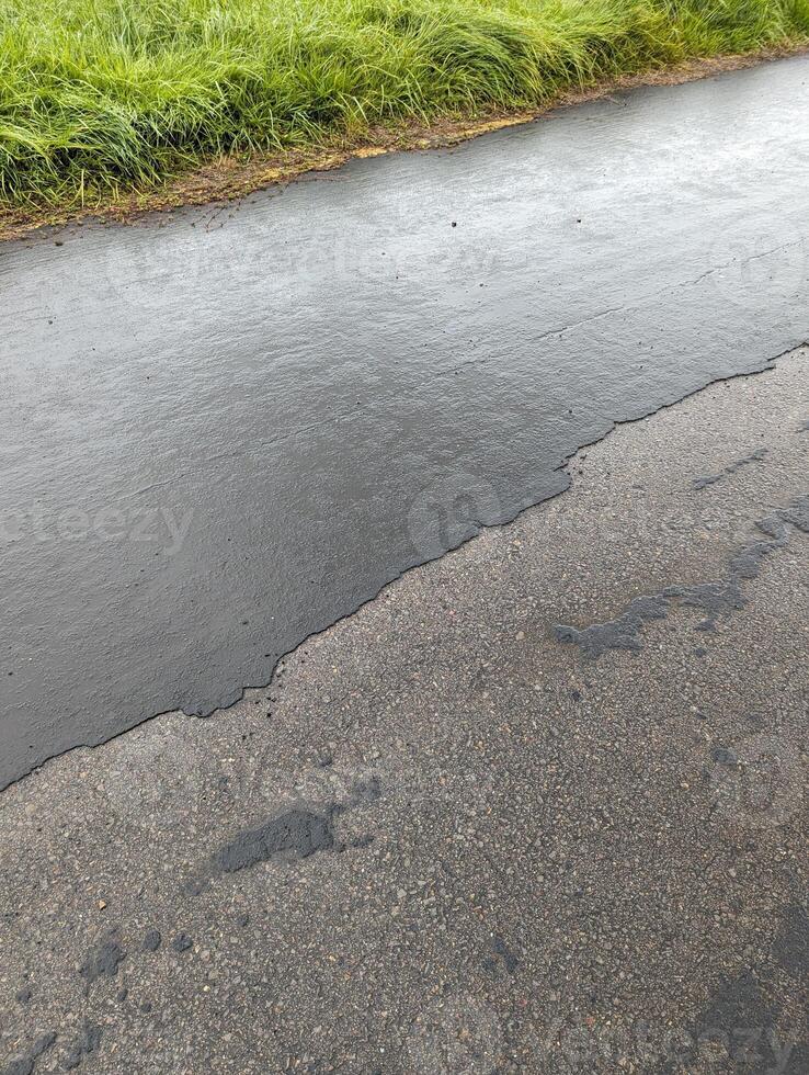 Deteriorating Asphalt and Concrete Road Surface in Wales photo