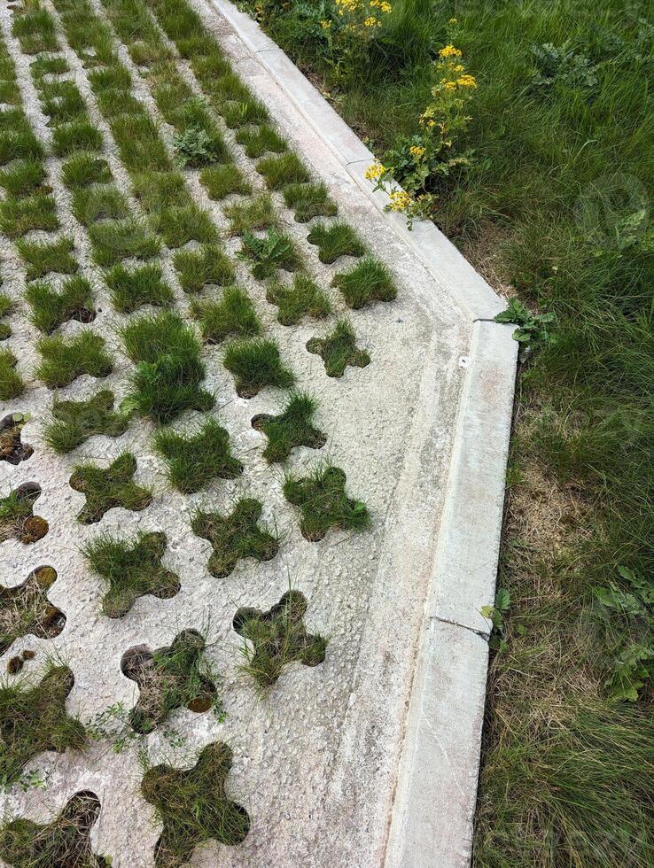 High Angle, Closeup View of Green Grasscrete Construction Maintenance Bay, adjacent to Highway photo
